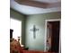 Bedroom with green walls and decorative cross at 115 The Falls Blvd, Covington, GA 30016