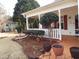 Inviting front porch with white railings and potted plants at 115 The Falls Blvd, Covington, GA 30016