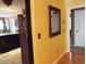 Short hallway with yellow walls and hardwood floors at 115 The Falls Blvd, Covington, GA 30016