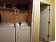 Laundry room with washer, dryer, and shelving at 115 The Falls Blvd, Covington, GA 30016