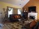 Living room with hardwood floors, fireplace and large windows at 115 The Falls Blvd, Covington, GA 30016