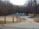 Well-lit tennis court in a wooded setting at 115 The Falls Blvd, Covington, GA 30016