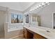 Main bathroom with double sinks, garden tub, and large window at 1440 Teaberry Cir, Lawrenceville, GA 30044