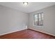 Simple bedroom with wood-look floors and large window at 1440 Teaberry Cir, Lawrenceville, GA 30044