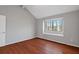 Bedroom with hardwood floors, large window, and neutral walls at 1440 Teaberry Cir, Lawrenceville, GA 30044