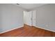 Bedroom with wood-look floors and access to closet and hallway at 1440 Teaberry Cir, Lawrenceville, GA 30044