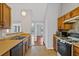 Galley-style kitchen with wood cabinets and gas stove at 1440 Teaberry Cir, Lawrenceville, GA 30044