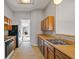 Full kitchen view with wood cabinets, gas range, and refrigerator at 1440 Teaberry Cir, Lawrenceville, GA 30044