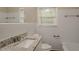 Bathroom with granite countertop, white tile, and bathtub at 1937 Windsor Sw Dr, Atlanta, GA 30311