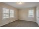 Well-lit bedroom with neutral walls and carpet flooring at 1937 Windsor Sw Dr, Atlanta, GA 30311