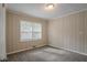 Bedroom with wood paneling, carpet, and neutral walls at 1937 Windsor Sw Dr, Atlanta, GA 30311