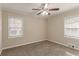 Bedroom with carpet, ceiling fan, and two windows at 1937 Windsor Sw Dr, Atlanta, GA 30311