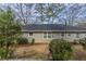 Rear view of gray brick house with yard at 1937 Windsor Sw Dr, Atlanta, GA 30311