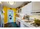 Well-equipped kitchen with white cabinetry, gas range, and a sunny yellow wall at 215 Piedmont Ne Ave # 1707, Atlanta, GA 30308