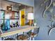 Mid-century style wet bar with wood cabinetry and colorful glassware at 215 Piedmont Ne Ave # 1707, Atlanta, GA 30308