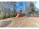 Playful backyard with a wooden playset at 2976 Cambridge Hill Dr, Dacula, GA 30019