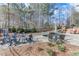 Expansive backyard with a pool, fire pit, and lush landscaping at 2976 Cambridge Hill Dr, Dacula, GA 30019