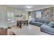 Finished basement with stone wall and sectional sofa at 2976 Cambridge Hill Dr, Dacula, GA 30019