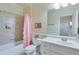 Bathroom with pink shower curtain and white vanity at 2976 Cambridge Hill Dr, Dacula, GA 30019