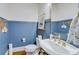 Stylish powder room with blue beadboard and a pedestal sink at 2976 Cambridge Hill Dr, Dacula, GA 30019