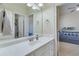 Bathroom with white vanity and view into bedroom at 2976 Cambridge Hill Dr, Dacula, GA 30019