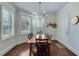 Bright dining room features a wood table, chairs, and plantation shutters at 2976 Cambridge Hill Dr, Dacula, GA 30019