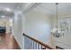 Elegant hallway with hardwood floors and chandelier at 2976 Cambridge Hill Dr, Dacula, GA 30019