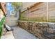 Private patio with gravel flooring, stone wall, and wooden fence at 1065 United Se Ave # 101, Atlanta, GA 30316