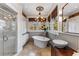 Bright bathroom with a soaking tub, walk-in shower, double windows, and vintage wood vanity at 1316 North Ne Ave, Atlanta, GA 30307