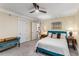 Bedroom featuring a comfortable bed, a modern ceiling fan, and a comfortable teal settee at 1316 North Ne Ave, Atlanta, GA 30307