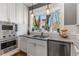 The modern kitchen boasts stainless steel appliances, granite countertops, and a bay window at 1316 North Ne Ave, Atlanta, GA 30307