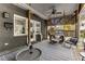 Relaxing covered brick porch with a swing, ceiling fan, stylish furniture, and textured outdoor rug at 1316 North Ne Ave, Atlanta, GA 30307