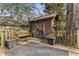 Charming backyard shed with rustic wooden doors, adjacent to a bench and greenery at 1316 North Ne Ave, Atlanta, GA 30307