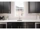 Modern kitchen with white subway tile backsplash and black cabinets at 17 Rockyford Ne Rd, Atlanta, GA 30317