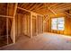 Unfinished room with wooden framing and large window at 17 Rockyford Ne Rd, Atlanta, GA 30317