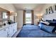 Blue and white bedroom with a large window and decorative pillows at 1934 Asher Ln # 060, Conyers, GA 30013