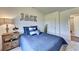 Bedroom with blue bedding, decorative pillows, and a full bath at 1934 Asher Ln # 060, Conyers, GA 30013