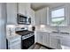 Bright kitchen with white cabinets, stainless steel appliances, and herringbone backsplash at 1934 Asher Ln # 060, Conyers, GA 30013