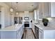 Modern kitchen with white cabinets, stainless steel appliances, and an island at 1934 Asher Ln # 060, Conyers, GA 30013