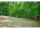 Wooded backyard with a slight incline and a small shed at 2010 Sturbridge Ln, Buford, GA 30519