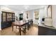 Bright dining room features hardwood floors and stylish dark cabinetry at 2010 Sturbridge Ln, Buford, GA 30519