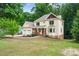 Two-story house with a spacious yard and attached garage, nestled among lush trees at 2010 Sturbridge Ln, Buford, GA 30519