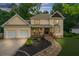 Two-story house with two-car garage and manicured lawn at 2010 Sturbridge Ln, Buford, GA 30519