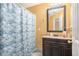 Bathroom with teal shower curtain and dark vanity at 2326 Nicole Dr, Hampton, GA 30228