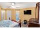 Bedroom with ensuite bathroom and large TV at 2326 Nicole Dr, Hampton, GA 30228