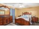 Spacious bedroom with wood furniture and ceiling fan at 2326 Nicole Dr, Hampton, GA 30228