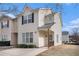 Two-story townhome with a charming front porch and well-manicured lawn at 2326 Nicole Dr, Hampton, GA 30228