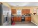 Modern kitchen with stainless steel appliances and wood cabinets at 2326 Nicole Dr, Hampton, GA 30228