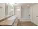 Bright bathroom features double sinks, a tub and shower combo, and new flooring at 161 Adair Se Ave, Atlanta, GA 30315