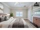 Staged primary bedroom with a bed and a brick fireplace at 161 Adair Se Ave, Atlanta, GA 30315